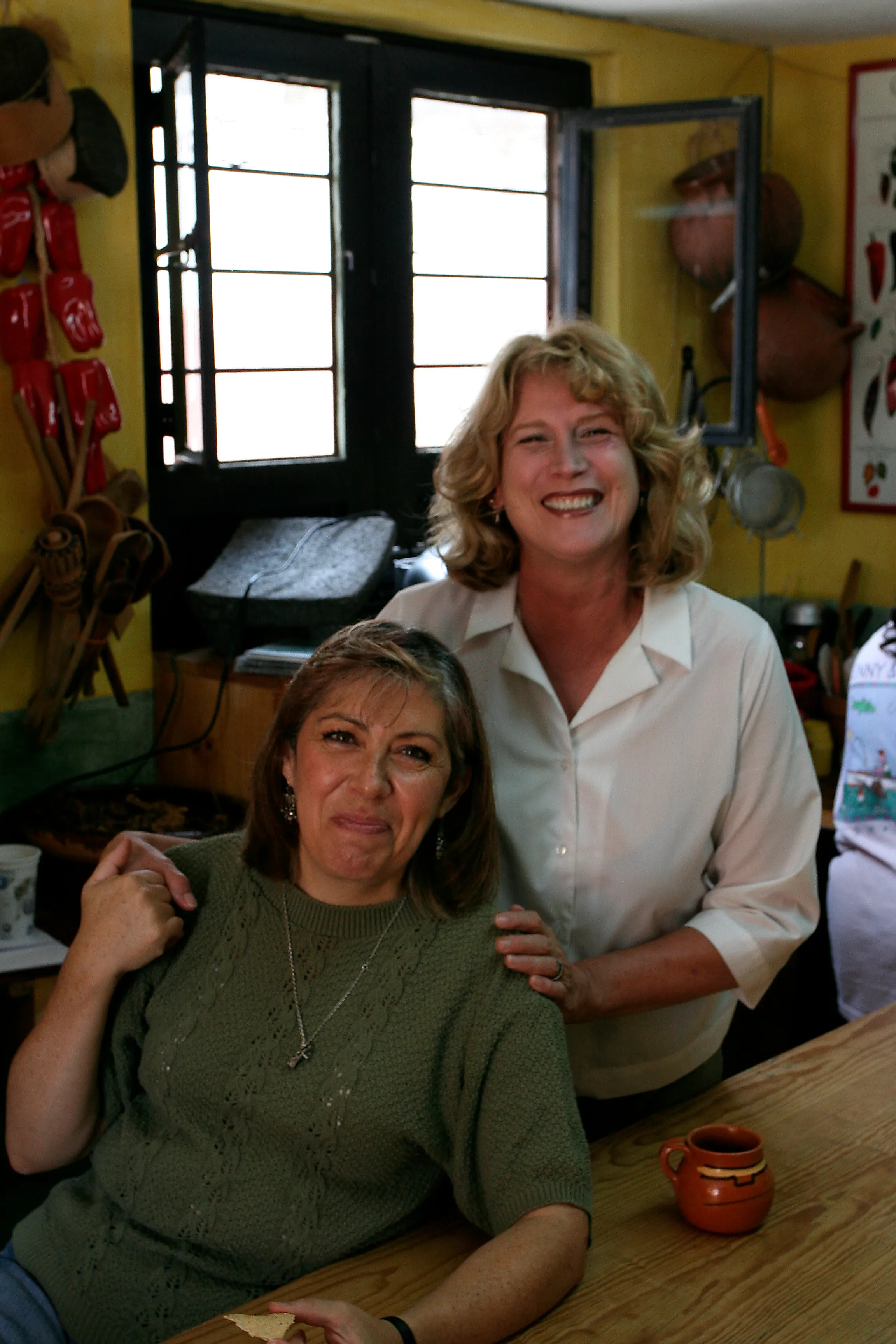 Two friends sharing a laugh at the class table