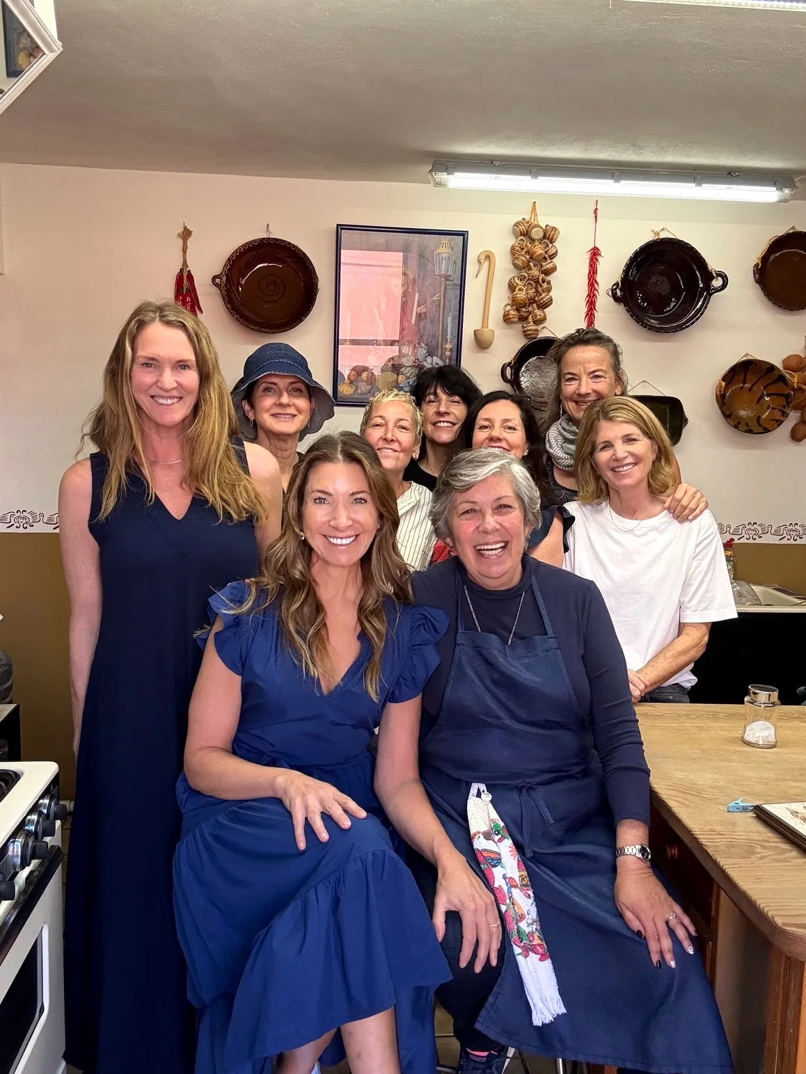 A women’s group gathered around Marilau in the kitchen